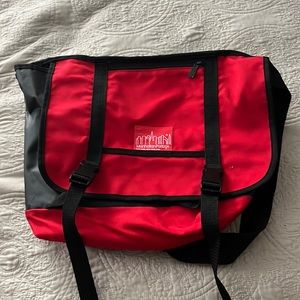 Red medium size Manhattan Portage messenger bag.